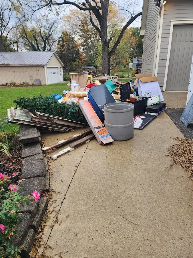Dumpster being loaded with debris for Demolition Dumpster Rental in Weare